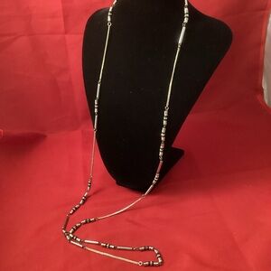 Long silver tone and black necklace